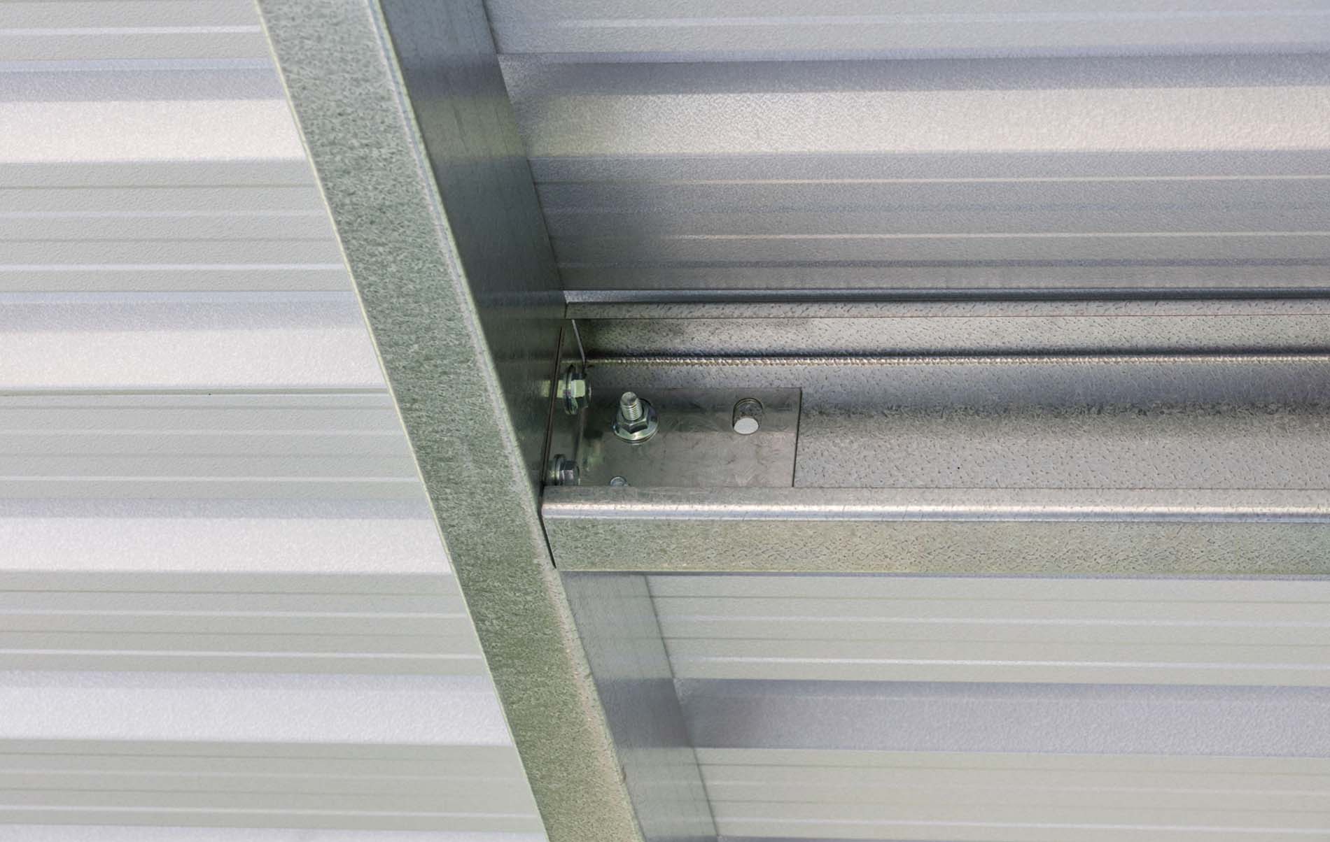 Spacious outdoor vehicle shelter with a flat roof and dark frame