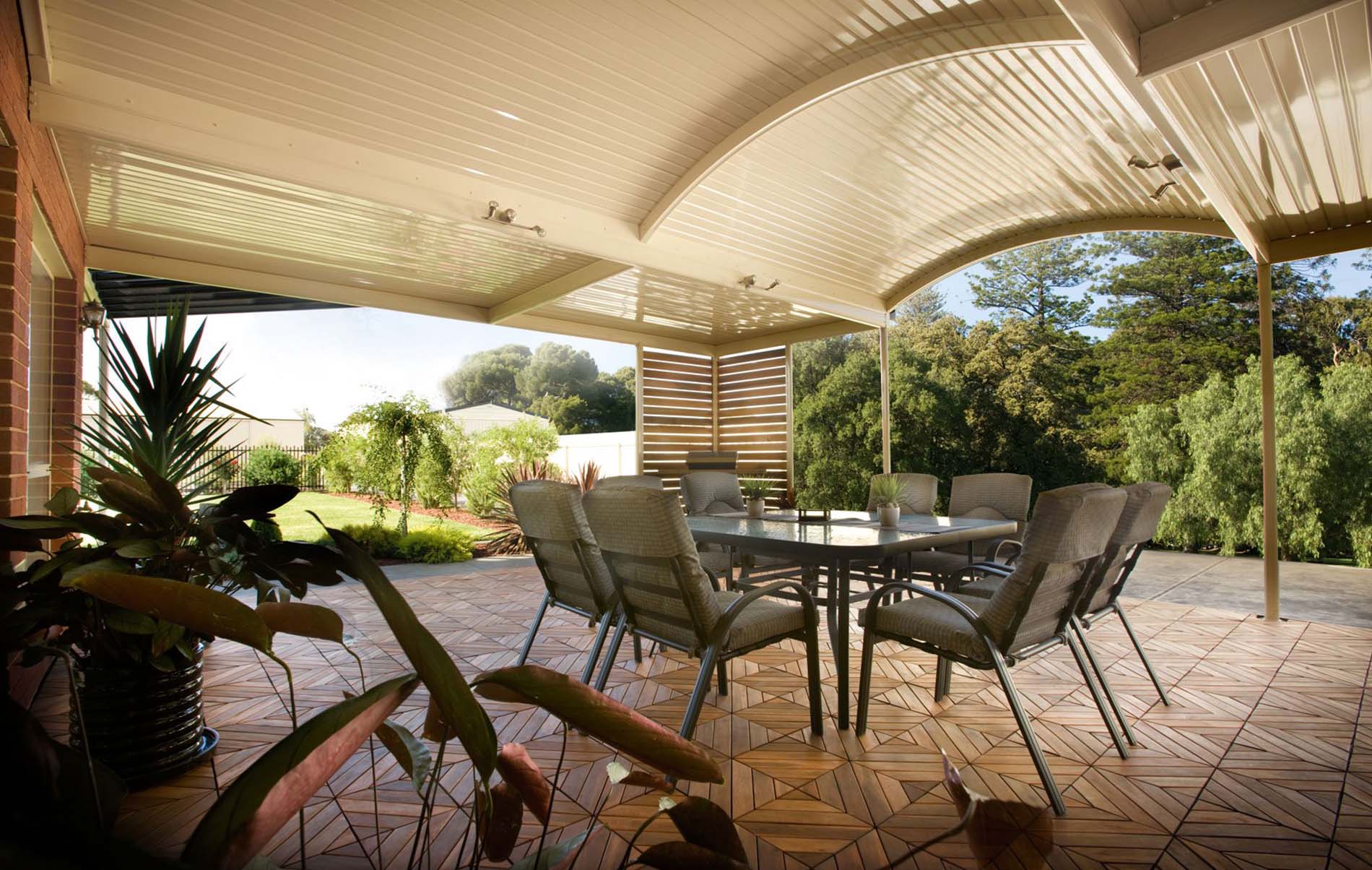 Freestanding curved patio structure with Colorbond roofing and outdoor seating