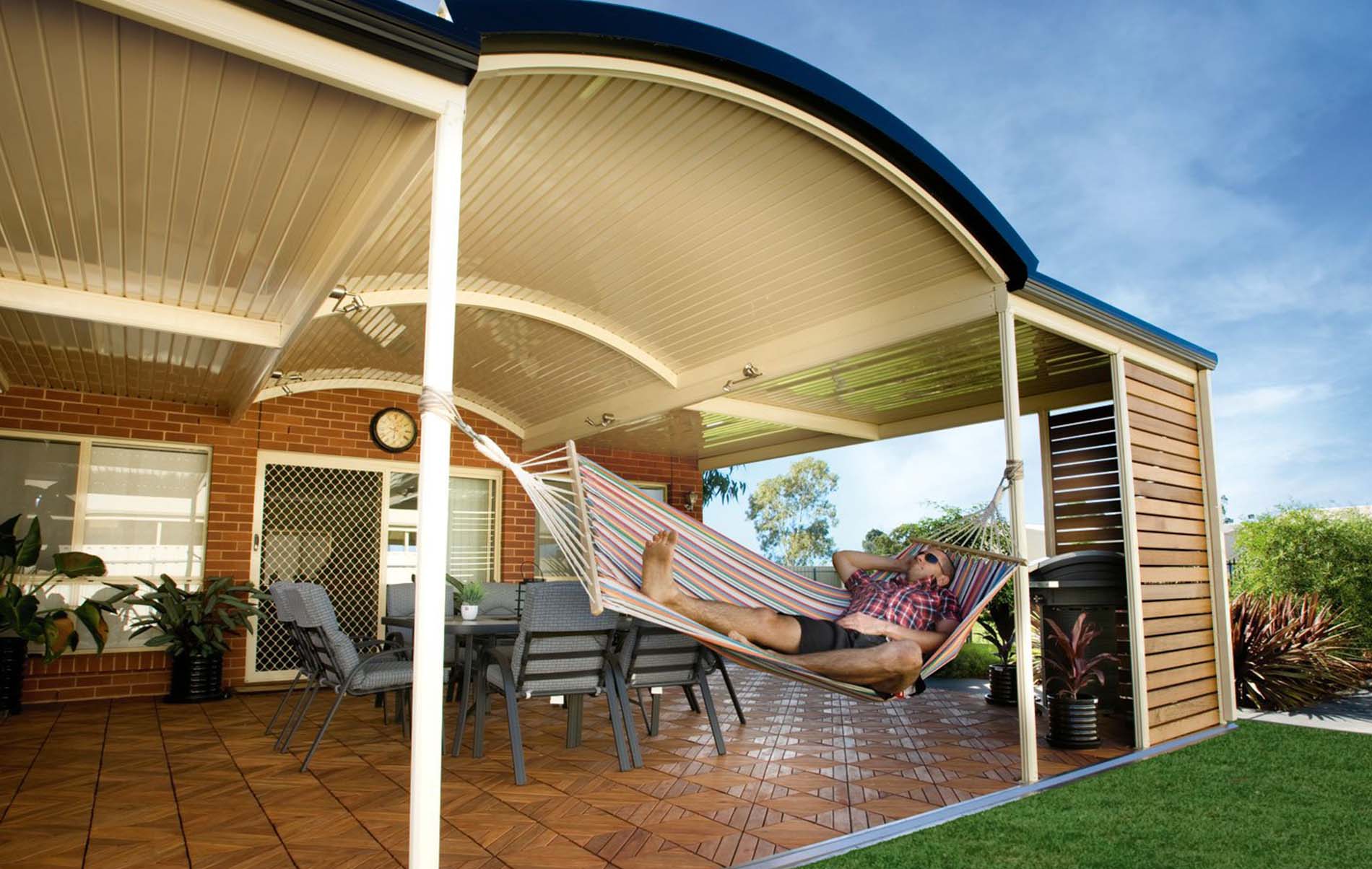 Daytime view of curved patio roof with polycarbonate panels