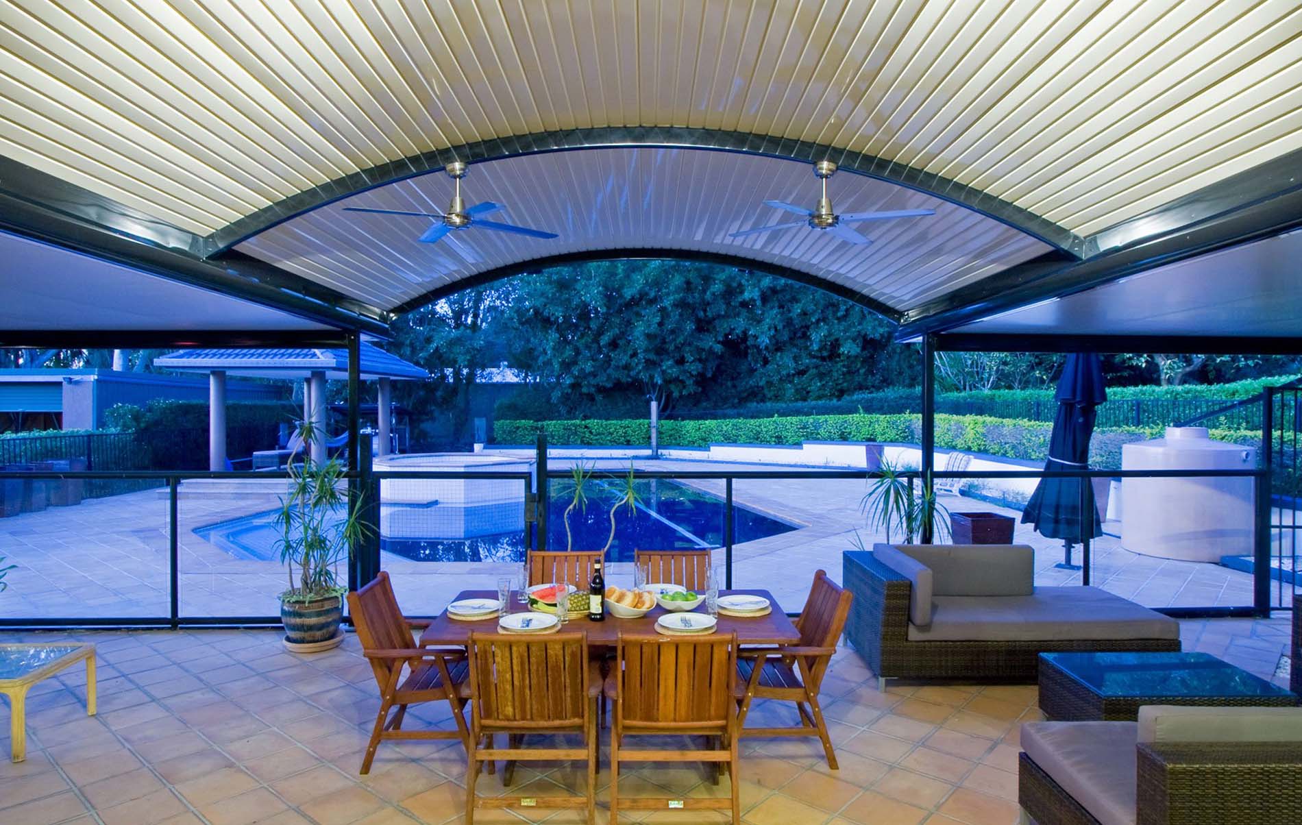 Attached curved patio with clearspan beams and outdoor lounge seating