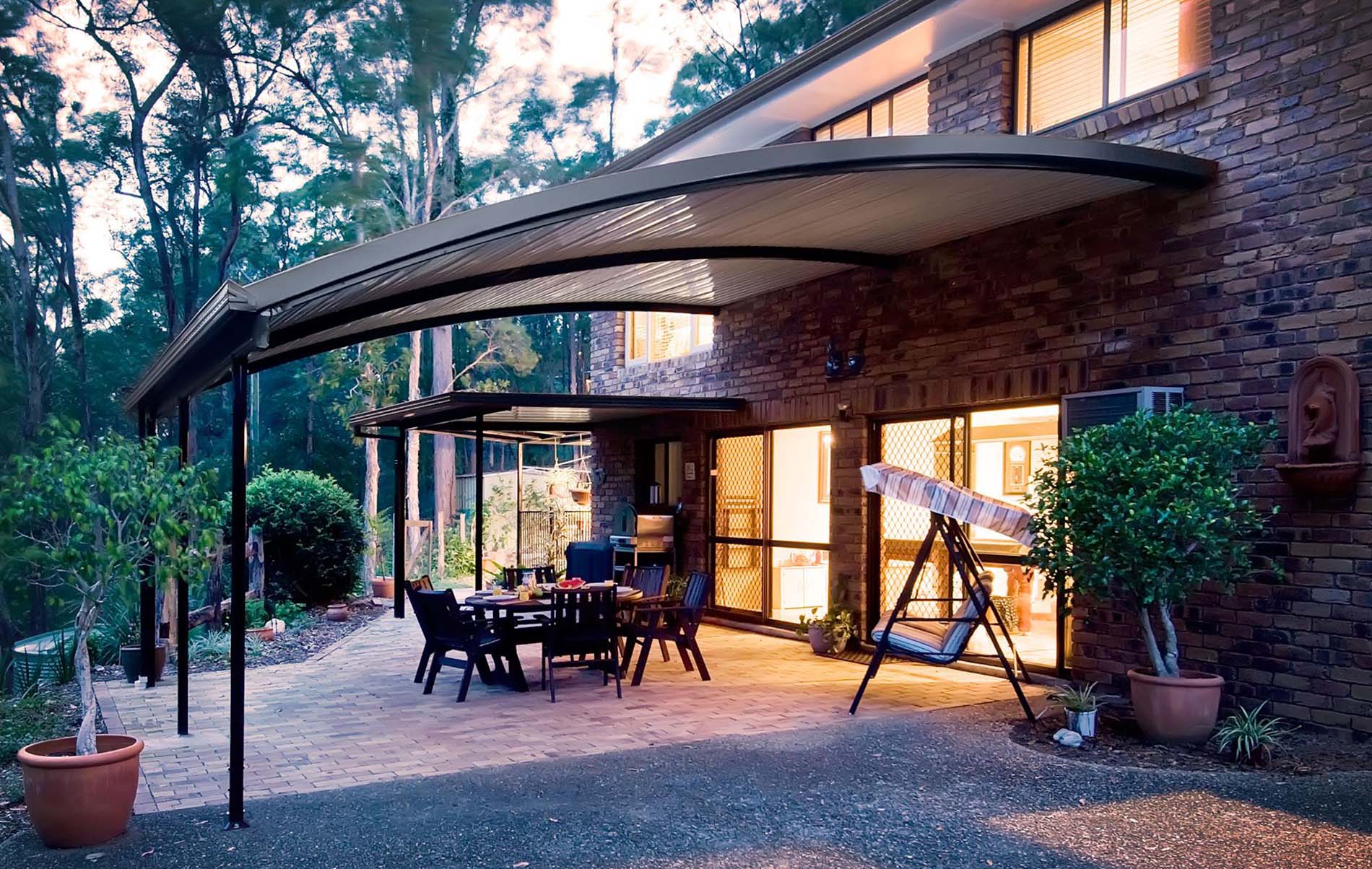 Freestanding curved patio structure with timber-look posts and Colorbond roofing