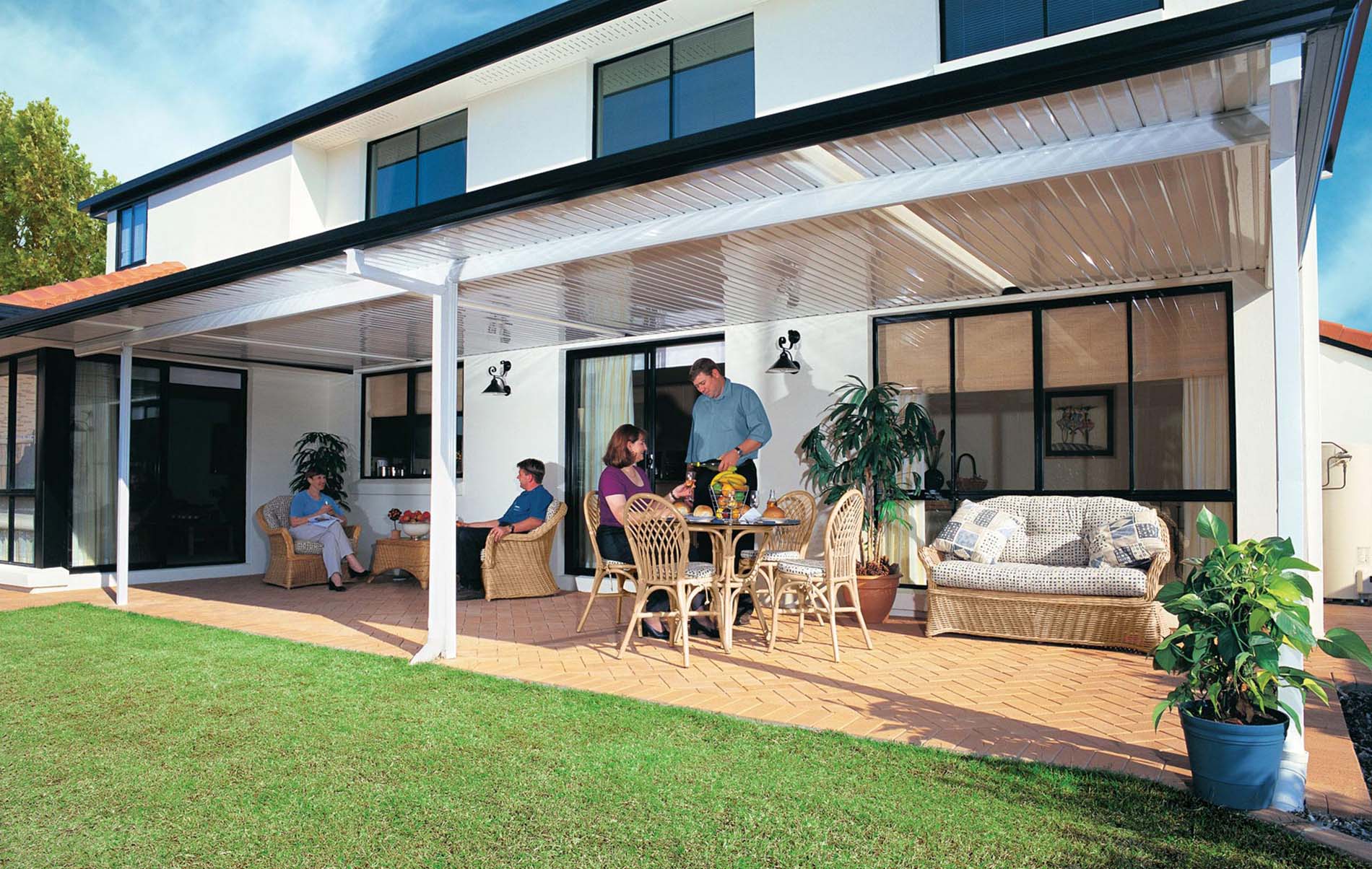 Spacious flat patio with clear roofing panels and outdoor seating