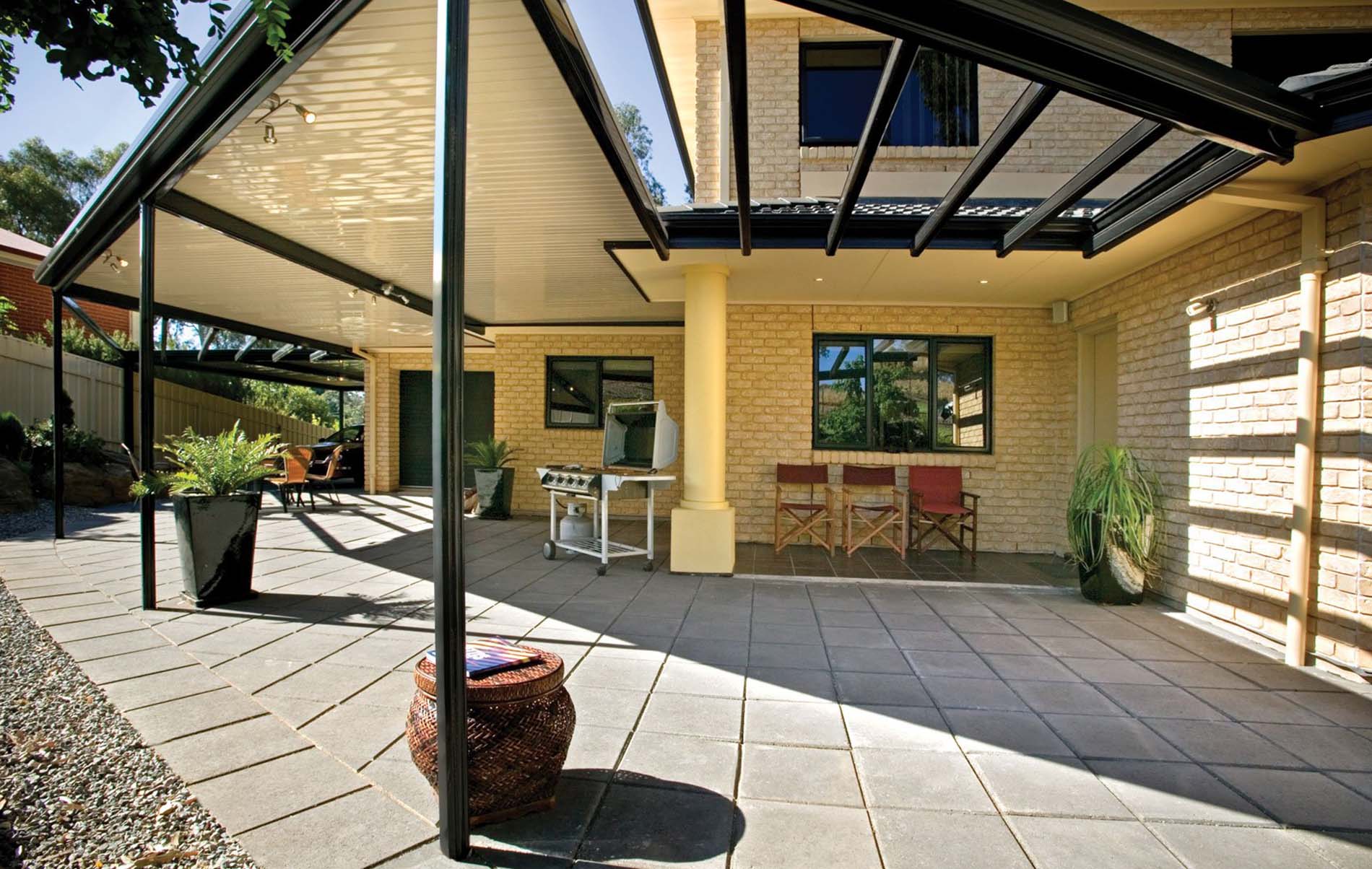 Freestanding flat patio structure in landscaped backyard