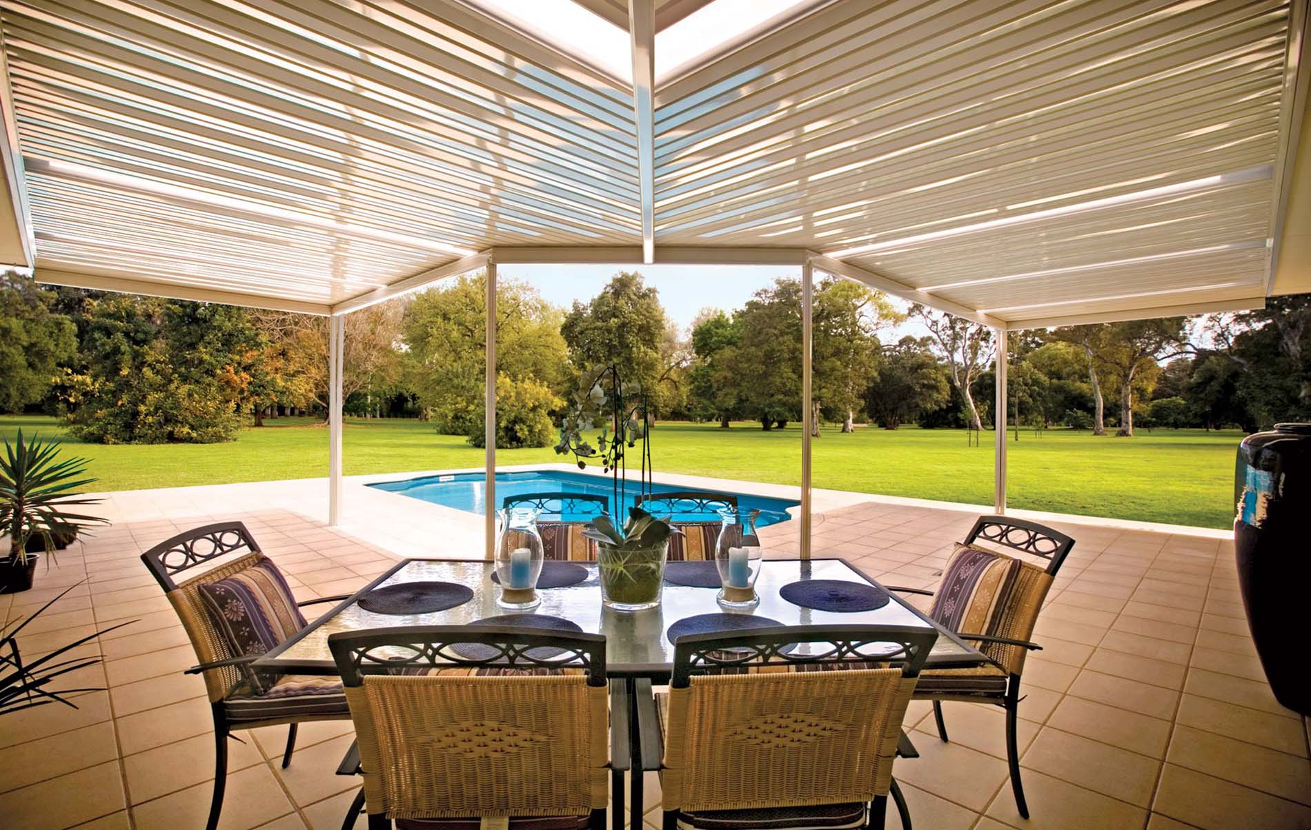 Modern flat patio with clear roofing and outdoor lounge furniture