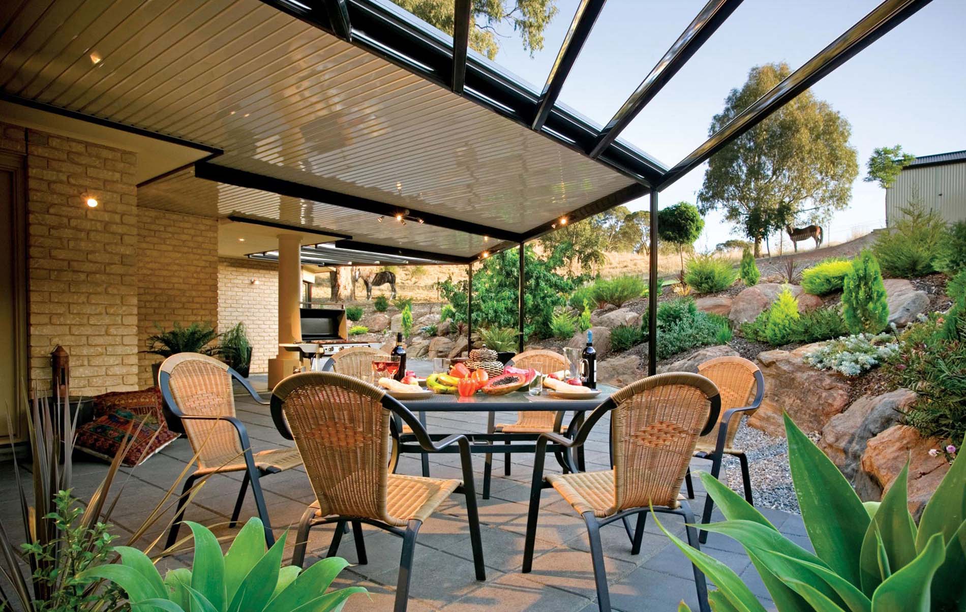Contemporary flat patio with sleek steel beams and integrated outdoor lighting against dusk sky
