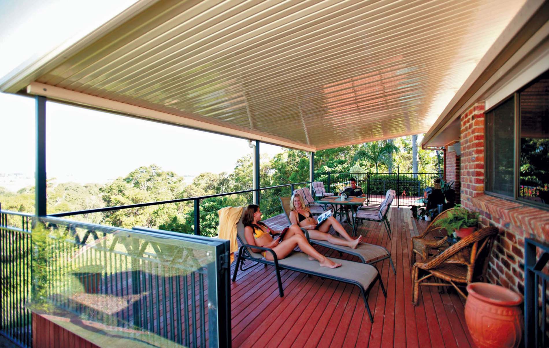 Modern flat patio with clear roofing and outdoor lounge furniture