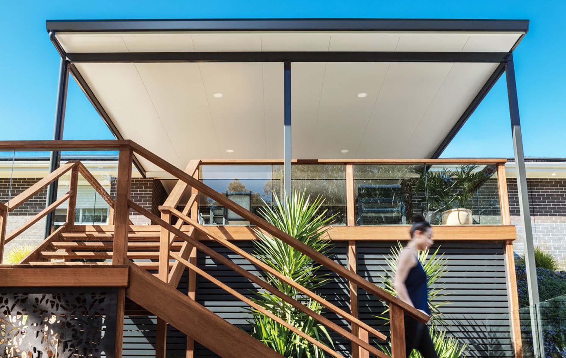 Spacious outdoor area with Stratco Cooldek flat roof patio, seamlessly blending with the home's architecture.