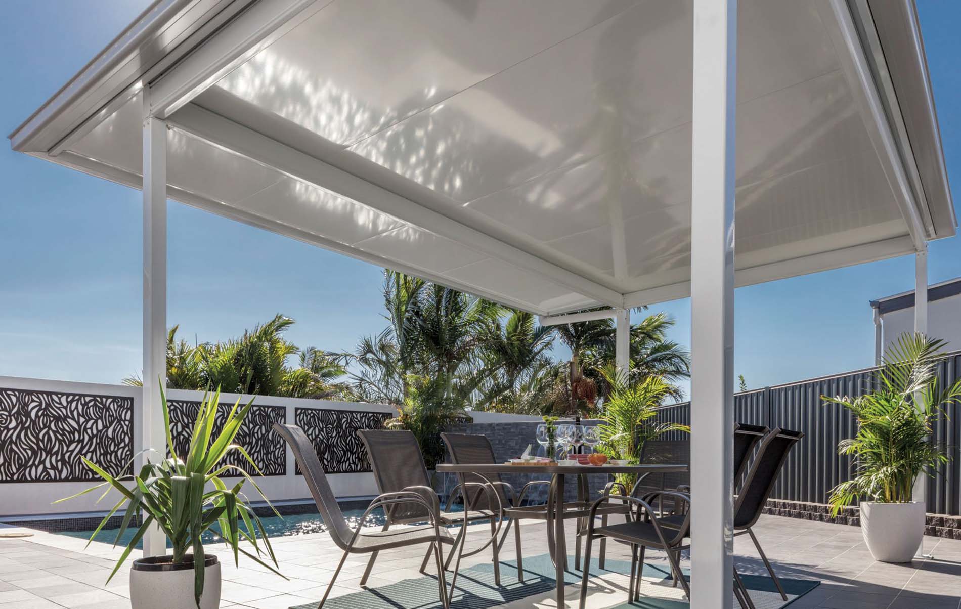 Outdoor entertainment area with Stratco Cooldek insulated roofing, providing a comfortable and stylish space.