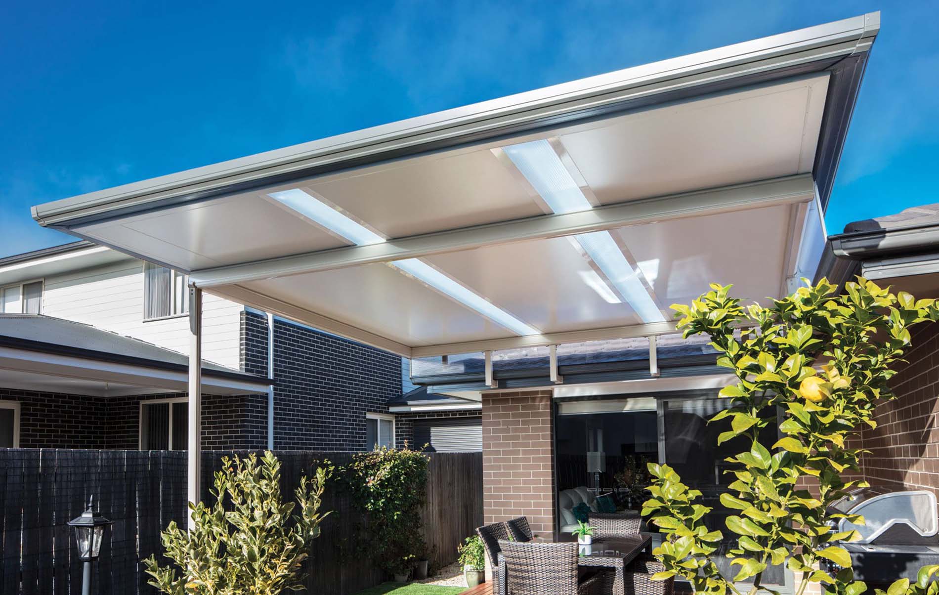 Stratco Cooldek flat roof patio with integrated lighting, enhancing the ambiance of the outdoor space.