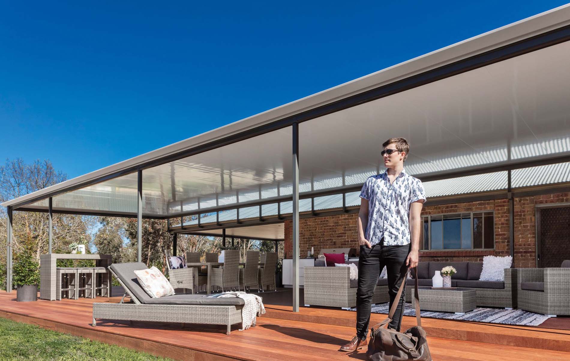 Elegant outdoor living area featuring Stratco Cooldek insulated roofing panels, offering both style and functionality.