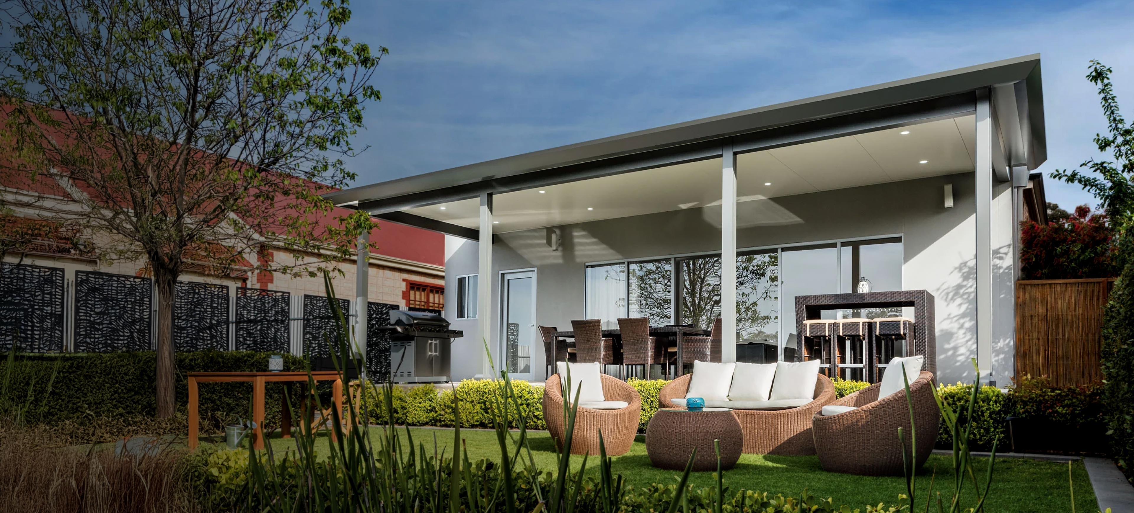 Modern verandah patio under roof with lounge seating and greenery