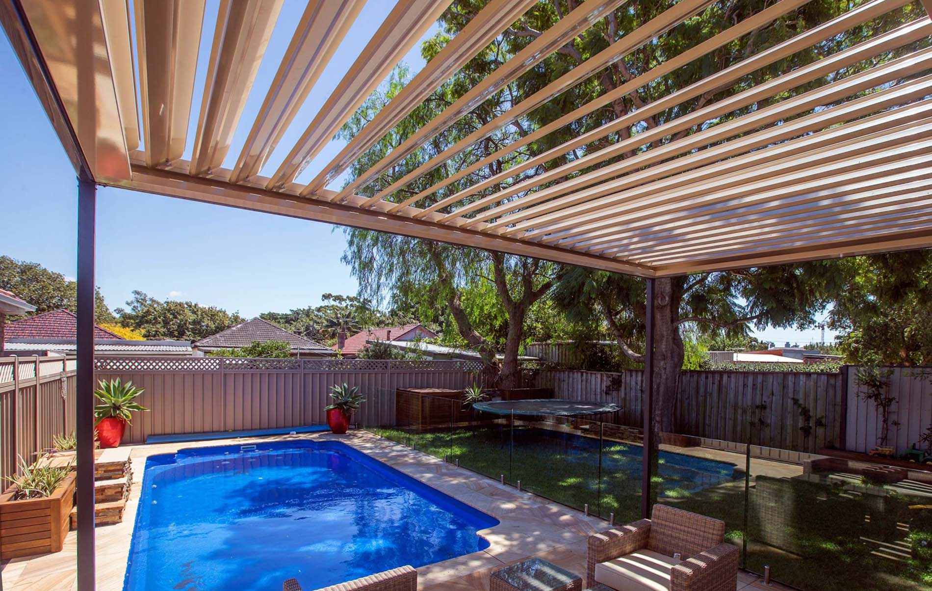 Modern louvre patio with adjustable roofing slats, ceiling fan and outdoor lounge seating