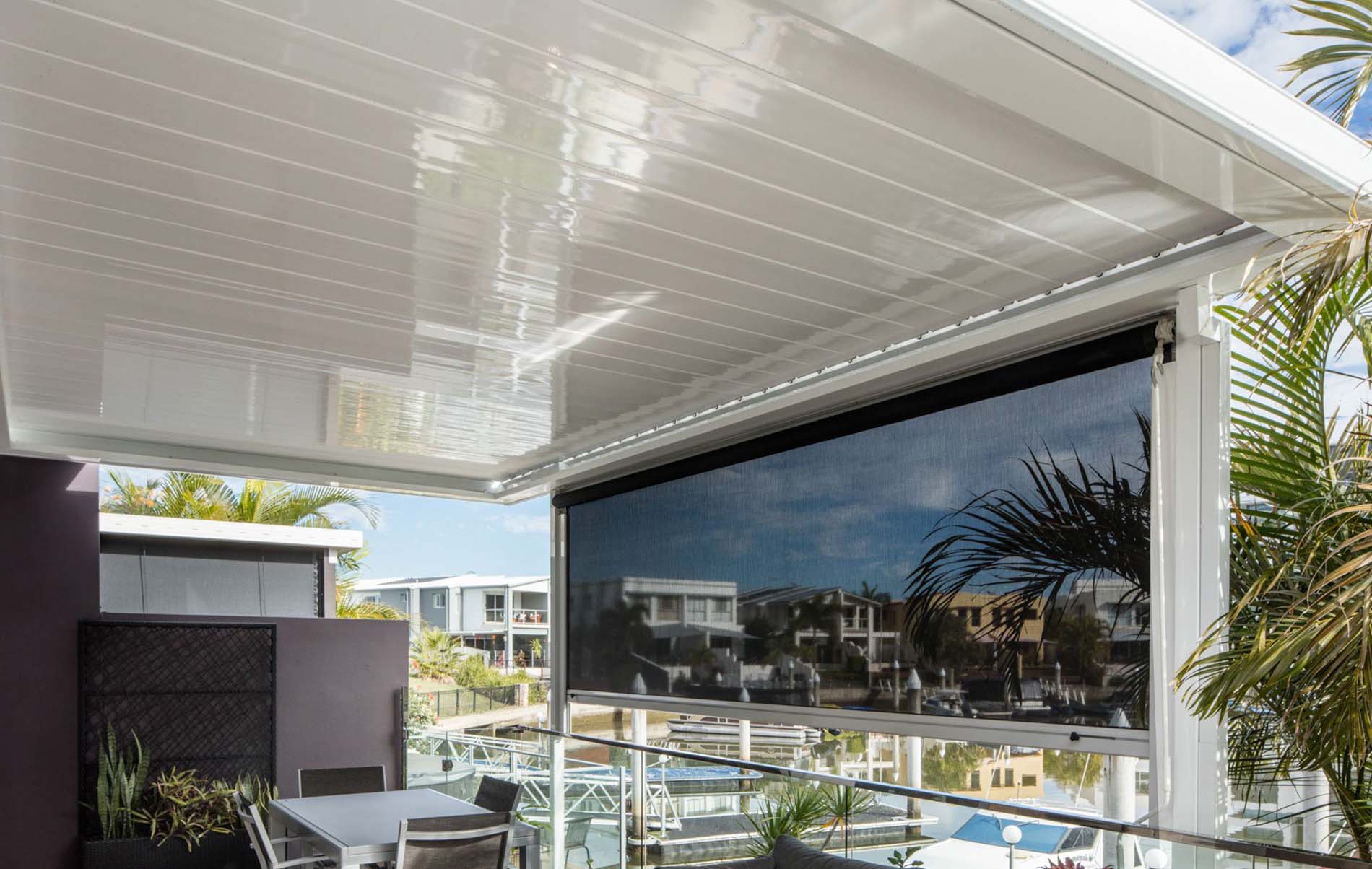 Aluminium louvre roof patio with adjustable slats and integrated lighting over timber deck