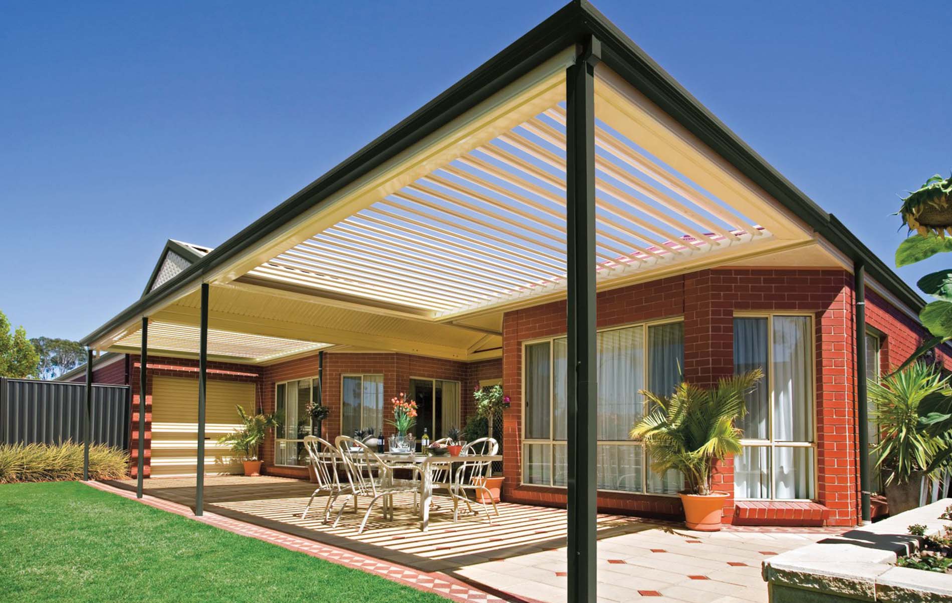 Automated louvre patio with sleek aluminium frame and partially opened roof slats over tiled floor