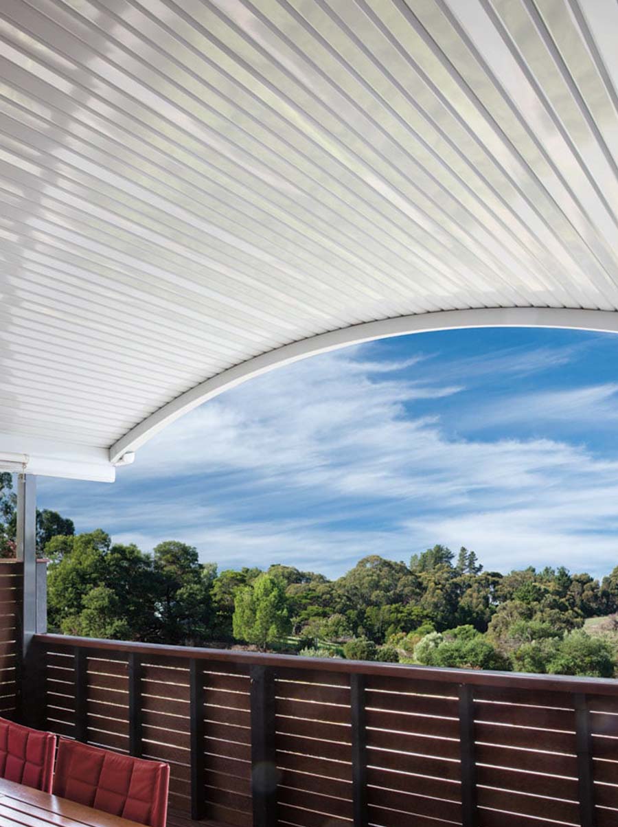 Portrait view of curved patio with white steel roof and elevated deck