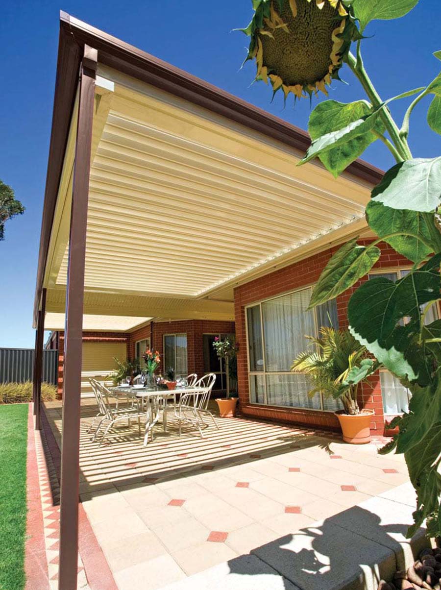 Modern patio featuring a sleek opening and closing louvre roof system with integrated lighting and rain sensor