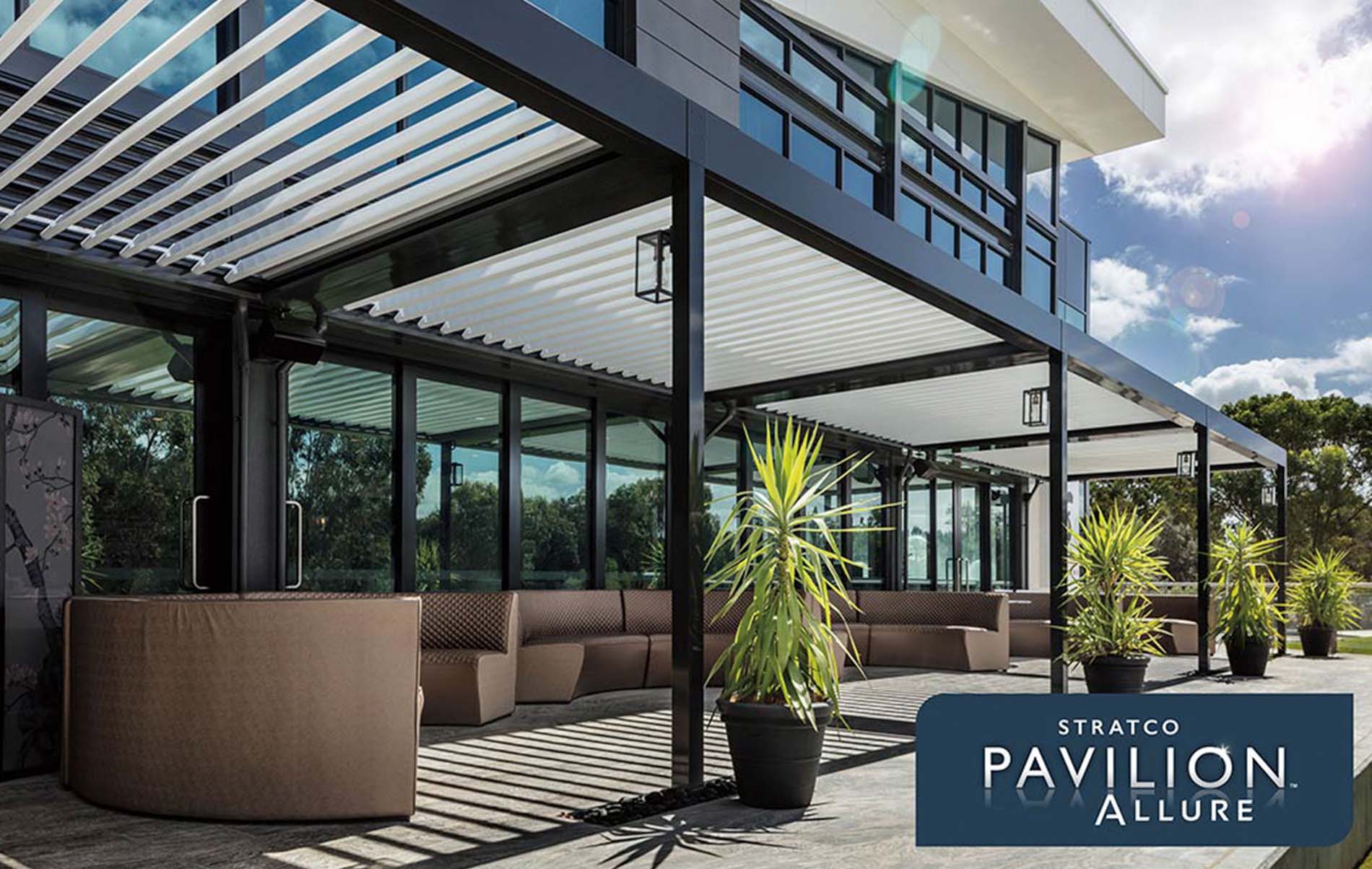 Modern outdoor verandah with wooden deck, stylish pergola roof, and comfortable seating area surrounded by greenery.